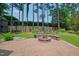 Lush backyard with a fire pit area, greenery, and a wooden fence at 1161 Golden Star Way, Wake Forest, NC 27587