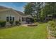 Expansive backyard featuring a stone patio, fire pit, and a play structure at 1161 Golden Star Way, Wake Forest, NC 27587