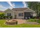 Inviting backyard with a patio, fire pit, raised garden bed, and mature trees at 1161 Golden Star Way, Wake Forest, NC 27587