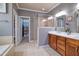 Bathroom featuring a walk-in shower, double vanity, and a view into an organized closet at 1161 Golden Star Way, Wake Forest, NC 27587