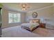 Bright bedroom with a large window, ceiling fan, and neutral color scheme at 1161 Golden Star Way, Wake Forest, NC 27587