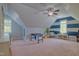 Spacious bonus room with a foosball table, ceiling fan, and natural light at 1161 Golden Star Way, Wake Forest, NC 27587