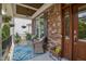 Inviting front porch with stone accents, comfortable seating, and decorative plants at 1161 Golden Star Way, Wake Forest, NC 27587