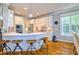 Bright kitchen with white cabinetry, counter seating, and stainless steel appliances at 1161 Golden Star Way, Wake Forest, NC 27587