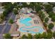 Aerial view of community pool with lazy river, ample seating, and clubhouse, offering resort-style amenities at 1161 Golden Star Way, Wake Forest, NC 27587