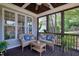 Relaxing screened-in porch with wicker furniture and a view of the landscaped backyard at 1161 Golden Star Way, Wake Forest, NC 27587
