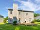 Back exterior of two story house with a wood deck overlooking a lush backyard at 117 Brierridge Dr, Apex, NC 27502