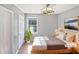 Cozy bedroom featuring natural light, neutral decor, and a modern ceiling fan at 117 Brierridge Dr, Apex, NC 27502