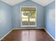 Bedroom features a window with nice outside view and wooden floors at 117 Brierridge Dr, Apex, NC 27502
