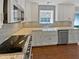 Well-equipped kitchen with white cabinets, granite countertops, and stainless steel appliances at 117 Brierridge Dr, Apex, NC 27502