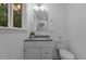 Updated bathroom features a modern vanity and a view to the outside at 1204 Pecan Pl, Durham, NC 27704