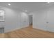 Bright bedroom features neutral walls, wood-look floors, and multiple closet doors at 1204 Pecan Pl, Durham, NC 27704