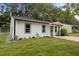 This is a charming white house with a cozy front yard at 1204 Pecan Pl, Durham, NC 27704