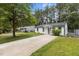 Quaint white home featuring a long driveway and fresh landscaping at 1204 Pecan Pl, Durham, NC 27704