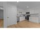 Bright kitchen with stainless steel appliances, white cabinets, and hardwood floors at 1204 Pecan Pl, Durham, NC 27704