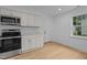 This kitchen features white cabinets, granite countertops, and stainless steel appliances at 1204 Pecan Pl, Durham, NC 27704