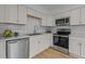 Modern kitchen featuring stainless steel appliances, sleek white cabinets, and stylish countertops at 1204 Pecan Pl, Durham, NC 27704
