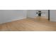 Bright living room features new floors and neutral walls adjacent to an updated kitchen at 1204 Pecan Pl, Durham, NC 27704