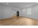 Large living room with great natural lighting, hardwood floors, and open to the kitchen and dining areas at 1204 Pecan Pl, Durham, NC 27704