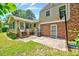 Beautiful backyard featuring a patio, lush lawn, and brick accents at 1209 Locharron Ln, Cary, NC 27511