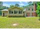 Spacious backyard with a well-maintained lawn and home with an attached sunroom and brick exterior at 1209 Locharron Ln, Cary, NC 27511