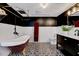 Unique bathroom with a clawfoot tub, black and white tile floors, and stylish vanity at 1209 Locharron Ln, Cary, NC 27511