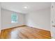 Bedroom with hardwood floors and a window that provides natural light to the room at 1209 Locharron Ln, Cary, NC 27511