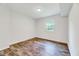 Bedroom with laminate floors and window providing natural light at 1209 Locharron Ln, Cary, NC 27511