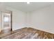 Bedroom featuring laminate floors and an entry way into a tiled bathroom at 1209 Locharron Ln, Cary, NC 27511