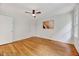Bright bedroom with wood flooring, ceiling fan, and natural light at 1209 Locharron Ln, Cary, NC 27511