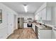 Updated kitchen featuring modern appliances, sleek white cabinetry, and ample counter space at 1209 Locharron Ln, Cary, NC 27511