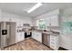 Bright kitchen featuring stainless steel appliances, white cabinets and modern countertops at 1209 Locharron Ln, Cary, NC 27511