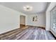 Open living room featuring wood floors, modern lighting, and a view into an adjacent room at 1209 Locharron Ln, Cary, NC 27511