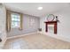 Cozy living room featuring a decorative fireplace, tile floors, and natural light from a window at 1209 Locharron Ln, Cary, NC 27511