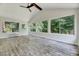 Bright sunroom with large windows and a ceiling fan; a perfect relaxation space at 1209 Locharron Ln, Cary, NC 27511
