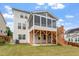 This home includes a well-maintained lawn and screened in porch at 125 Durban Meadow Dr, Holly Springs, NC 27540