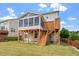 This home includes a well-maintained yard, screened in porch, and deck with stairs at 125 Durban Meadow Dr, Holly Springs, NC 27540