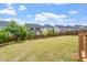 Well-maintained backyard with a wooden fence, grass, and manicured landscaping at 125 Durban Meadow Dr, Holly Springs, NC 27540