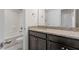 Bathroom featuring granite counters, dark wood cabinets, and a shower-tub combination at 125 Durban Meadow Dr, Holly Springs, NC 27540