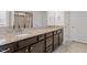 Bathroom featuring granite countertops and dark cabinetry with double sinks at 125 Durban Meadow Dr, Holly Springs, NC 27540