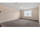 Large bedroom featuring neutral walls, carpet flooring, and a window with natural light at 125 Durban Meadow Dr, Holly Springs, NC 27540