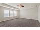 Large bedroom with tray ceiling, neutral walls, carpet, and large windows, offering ample space at 125 Durban Meadow Dr, Holly Springs, NC 27540