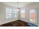 A breakfast nook featuring three large windows and an exterior door at 125 Durban Meadow Dr, Holly Springs, NC 27540