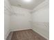 Walk-in closet providing ample storage with wire shelving installed on the walls at 125 Durban Meadow Dr, Holly Springs, NC 27540