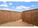 An enclosed deck with wood flooring and privacy screening against a blue sky at 125 Durban Meadow Dr, Holly Springs, NC 27540