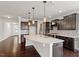 A kitchen with dark cabinets, an island with light countertops, and pendant lighting at 125 Durban Meadow Dr, Holly Springs, NC 27540