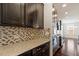 Close-up of kitchen showcasing granite countertops, tile backsplash, and stainless steel appliances at 125 Durban Meadow Dr, Holly Springs, NC 27540