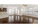 A living room featuring a breakfast bar, multiple windows, and a doorway to the exterior at 125 Durban Meadow Dr, Holly Springs, NC 27540
