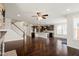 Open concept floor plan with kitchen island, dark cabinets, and a brick fireplace at 125 Durban Meadow Dr, Holly Springs, NC 27540