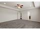 Spacious main bedroom with a ceiling fan, neutral walls, and an en-suite bathroom at 125 Durban Meadow Dr, Holly Springs, NC 27540